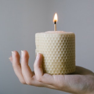 A candle a hand model's palm