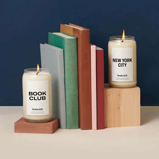 Two candles separated by a few books in between
