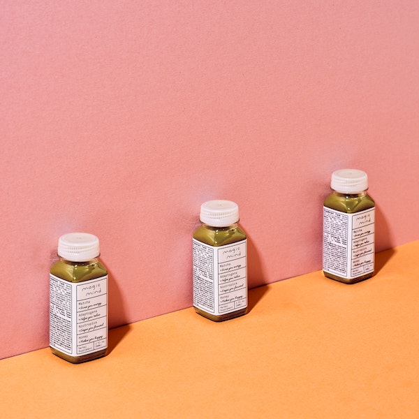 Three bottles of supplements against a two-colored backdrop