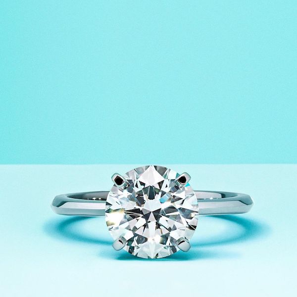 A Tiffany & Co. ring in a turquoise background