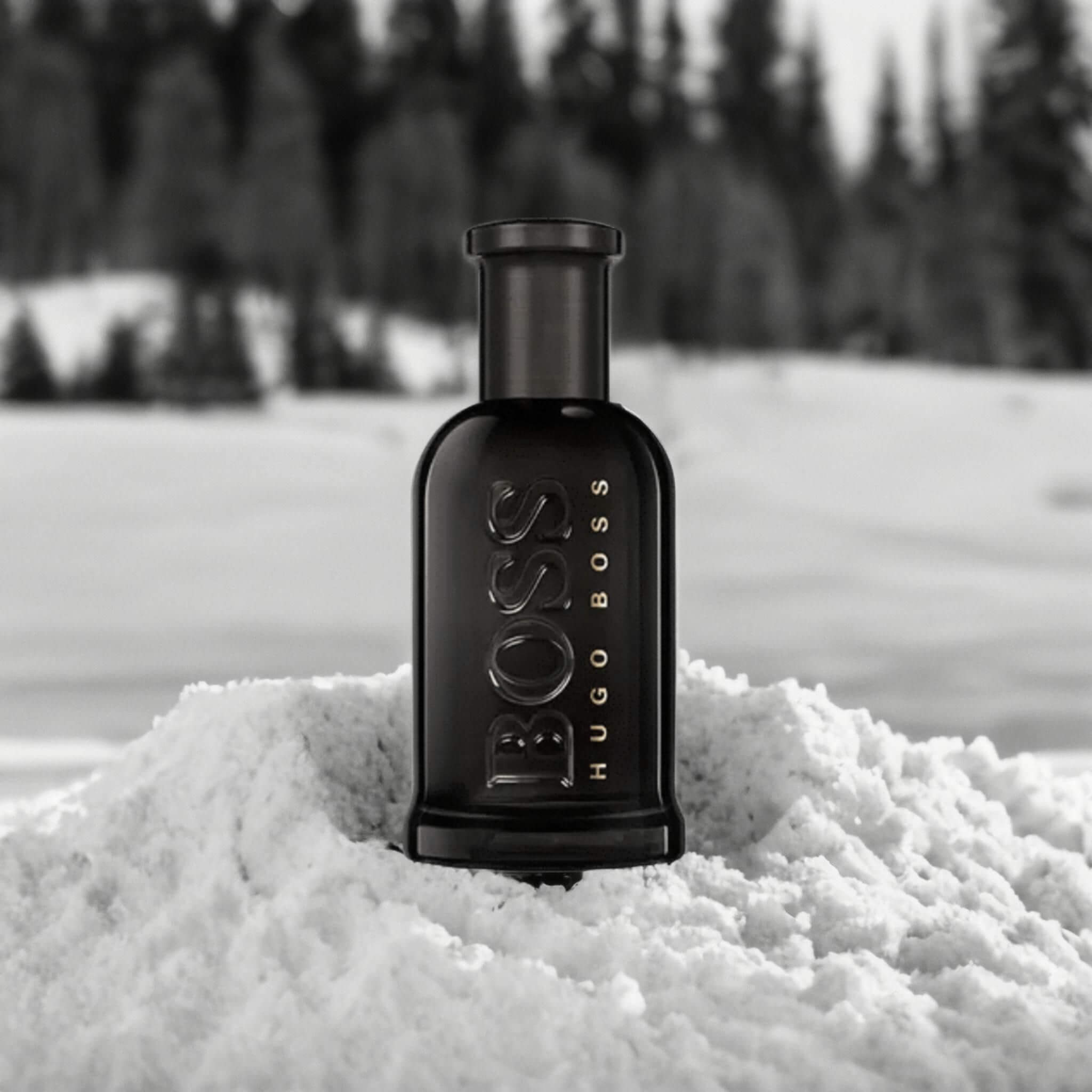 A black and white image of HUGO BOSS BOTTLED in snow