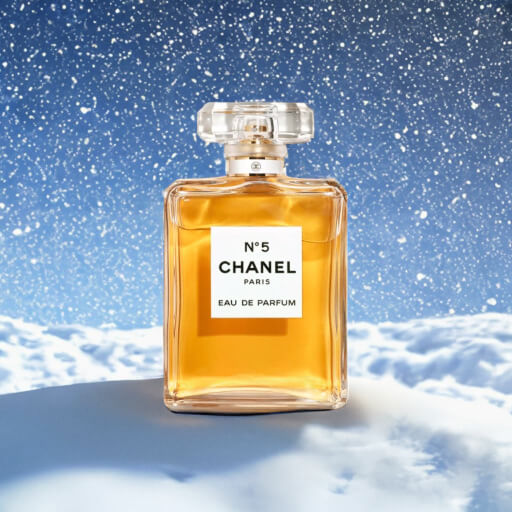 A photo of Chanel No. 5 with falling snow in the background