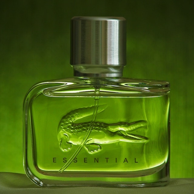 A photo of Lacoste Essential in a green backdrop